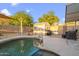 Backyard pool and patio area featuring a custom storage shed and mature desert landscaping at 3102 W Louise Dr, Phoenix, AZ 85027