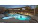 Sparkling pool with waterfall feature, spa, and shaded lounging area, perfect for outdoor relaxation and entertainment at 3102 W Louise Dr, Phoenix, AZ 85027