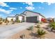 Modern home with desert landscaping and a two-car garage at 3560 N Mia Ln, Casa Grande, AZ 85122