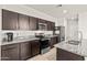 Modern kitchen with dark wood cabinets and granite countertops at 3560 N Mia Ln, Casa Grande, AZ 85122