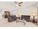 Comfortable living room with leather reclining furniture and a ceiling fan at 3560 N Mia Ln, Casa Grande, AZ 85122