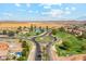 Aerial view of a residential area with a lake and roundabout at 36060 W San Ildefanso Ave, Maricopa, AZ 85138