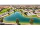 Aerial view of neighborhood with lake, park, and playground at 36060 W San Ildefanso Ave, Maricopa, AZ 85138