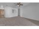 Bright living room with neutral carpeting and ceiling fan at 40440 N High Meadows Dr, San Tan Valley, AZ 85140