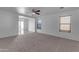 Open living room with neutral carpeting and ceiling fan at 40440 N High Meadows Dr, San Tan Valley, AZ 85140