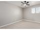 Spacious bedroom featuring a ceiling fan and light walls at 4263 W Morten Ave, Phoenix, AZ 85051