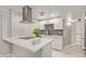 Modern kitchen with white shaker cabinets, stainless steel appliances, and a quartz island at 4263 W Morten Ave, Phoenix, AZ 85051