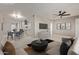 Bright living room with contemporary furnishings and a view into the kitchen and dining area at 4263 W Morten Ave, Phoenix, AZ 85051