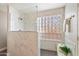 Elegant bathroom with marble tile, a large shower, and a glass block window at 4330 N Ranier Cir, Mesa, AZ 85215