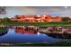 Grand clubhouse reflecting in a tranquil pond on a lush green golf course at 4330 N Ranier Cir, Mesa, AZ 85215