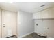 Functional laundry room with built-in cabinets and a pet door at 4330 N Ranier Cir, Mesa, AZ 85215