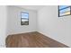 Bright bedroom with wood-look tile, neutral color, and large window at 4388 N 203Rd Dr, Buckeye, AZ 85396