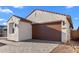 Charming single-story home with a two-car garage and a well-maintained brick driveway and landscaped yard at 4388 N 203Rd Dr, Buckeye, AZ 85396