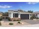 Craftsman style home with dark brown garage door, stone accents, and landscaping at 4388 N 203Rd Dr, Buckeye, AZ 85396