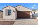 Charming single-story home with a two-car garage and a well-maintained brick driveway and landscaped yard at 4388 N 203Rd Dr, Buckeye, AZ 85396