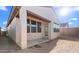 Exterior showcasing covered patio, stucco, dark framed windows, and red tile roof under a sunny sky at 4388 N 203Rd Dr, Buckeye, AZ 85396