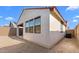 Back exterior view showcasing stucco, dark framed windows, and a red tile roof under a clear blue sky at 4388 N 203Rd Dr, Buckeye, AZ 85396