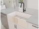 Farmhouse sink with matte black faucet in a white kitchen at 4388 N 203Rd Dr, Buckeye, AZ 85396