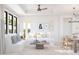 Living room with white couch, wood coffee table, and ceiling fan at 4388 N 203Rd Dr, Buckeye, AZ 85396