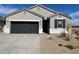 One-story house with a two-car garage and desert landscaping at 470 W Freedom St, Florence, AZ 85132