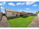 Wide view of backyard featuring lush green grass, rock features, and covered patio at 480 E Bart Dr, Chandler, AZ 85225