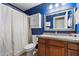 Bathroom showcasing blue walls, wooden vanity, decorative mirror, shower, and toilet at 480 E Bart Dr, Chandler, AZ 85225