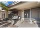 Inviting front porch featuring a cozy swing, decorative lanterns, and a secure screened door at 480 E Bart Dr, Chandler, AZ 85225