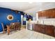 Open kitchen featuring dark wood cabinets, stainless steel appliances, and an adjacent dining area at 480 E Bart Dr, Chandler, AZ 85225