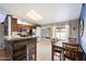 Open kitchen featuring dark wood cabinets, stainless steel appliances, and an adjacent dining area at 480 E Bart Dr, Chandler, AZ 85225