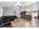 Spacious living room featuring tile flooring, ceiling fan, and a stylish wood plank accent wall at 480 E Bart Dr, Chandler, AZ 85225