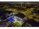 Night aerial view of home with a backyard pool, deck, and lush green lawn at 5344 E Catalina Ave, Mesa, AZ 85206