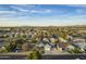 Daytime aerial view of a two story gray home surrounded by city and mountains at 5344 E Catalina Ave, Mesa, AZ 85206