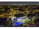 Night aerial view of home with a backyard pool, deck, and lush green lawn at 5344 E Catalina Ave, Mesa, AZ 85206