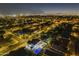 Expansive aerial view of a neighborhood featuring illuminated homes and a private pool at night at 5344 E Catalina Ave, Mesa, AZ 85206