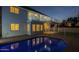 Evening shot of the backyard pool reflecting home's lights and upper level balcony at 5344 E Catalina Ave, Mesa, AZ 85206