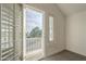 Balcony room with neutral carpet, shuttered windows, and sunny neighborhood views at 5344 E Catalina Ave, Mesa, AZ 85206