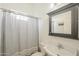 Clean bathroom featuring a pedestal sink, a shower with a curtain, and a vanity mirror, offering a practical and functional space at 5344 E Catalina Ave, Mesa, AZ 85206