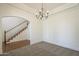 Formal dining room featuring a modern chandelier and stairway, perfect for hosting elegant dinners, with neutral colors at 5344 E Catalina Ave, Mesa, AZ 85206