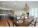 Elegant dining area adjacent to a kitchen with a chandelier and hardwood floors at 5344 E Catalina Ave, Mesa, AZ 85206