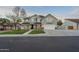 Charming two-story gray home featuring a well-manicured lawn and a cozy front porch at 5344 E Catalina Ave, Mesa, AZ 85206