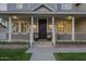 Charming front porch with brick accents, black door, and stylish lighting at 5344 E Catalina Ave, Mesa, AZ 85206