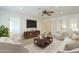 Cozy living room features a ceiling fan, neutral tones, and a modern entertainment center at 5344 E Catalina Ave, Mesa, AZ 85206