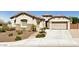 Tan colored house with a three-car garage and walkway at 5612 W Alyssa Ln, Phoenix, AZ 85083