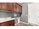 Laundry room with wooden cabinets and a sink at 5612 W Alyssa Ln, Phoenix, AZ 85083