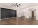 Open living room with dark accent wall and tile floors at 5612 W Alyssa Ln, Phoenix, AZ 85083