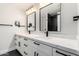 Bathroom features white double vanity, quartz countertop, and modern fixtures at 6809 E Gelding Dr, Scottsdale, AZ 85254