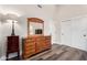 Bedroom features wood dresser with mirror and new wood-style flooring at 6809 E Gelding Dr, Scottsdale, AZ 85254