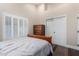 Bedroom with wood floors, bright shutters and closet at 6809 E Gelding Dr, Scottsdale, AZ 85254