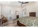 Spacious main bedroom featuring wood floors, and ensuite bathroom access at 6809 E Gelding Dr, Scottsdale, AZ 85254