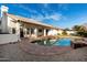 Backyard pool area with updated landscaping at 6809 E Gelding Dr, Scottsdale, AZ 85254